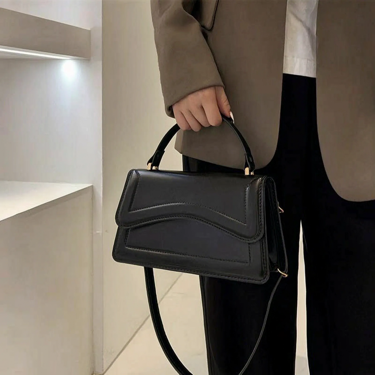 Compact structured shoulder bag with adjustable crossbody strap and magnetic flap closure