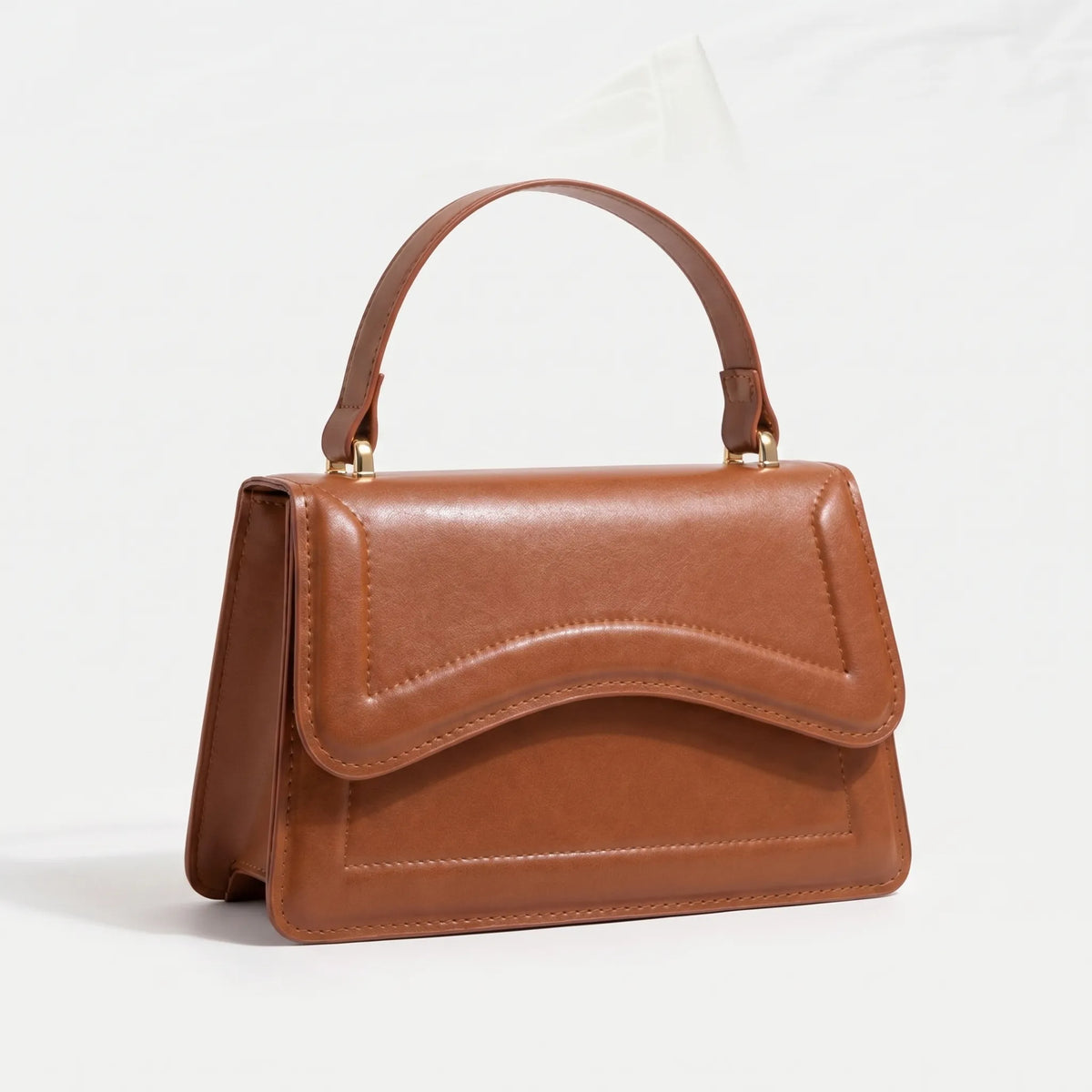 Compact structured shoulder bag with adjustable crossbody strap and magnetic flap closure
