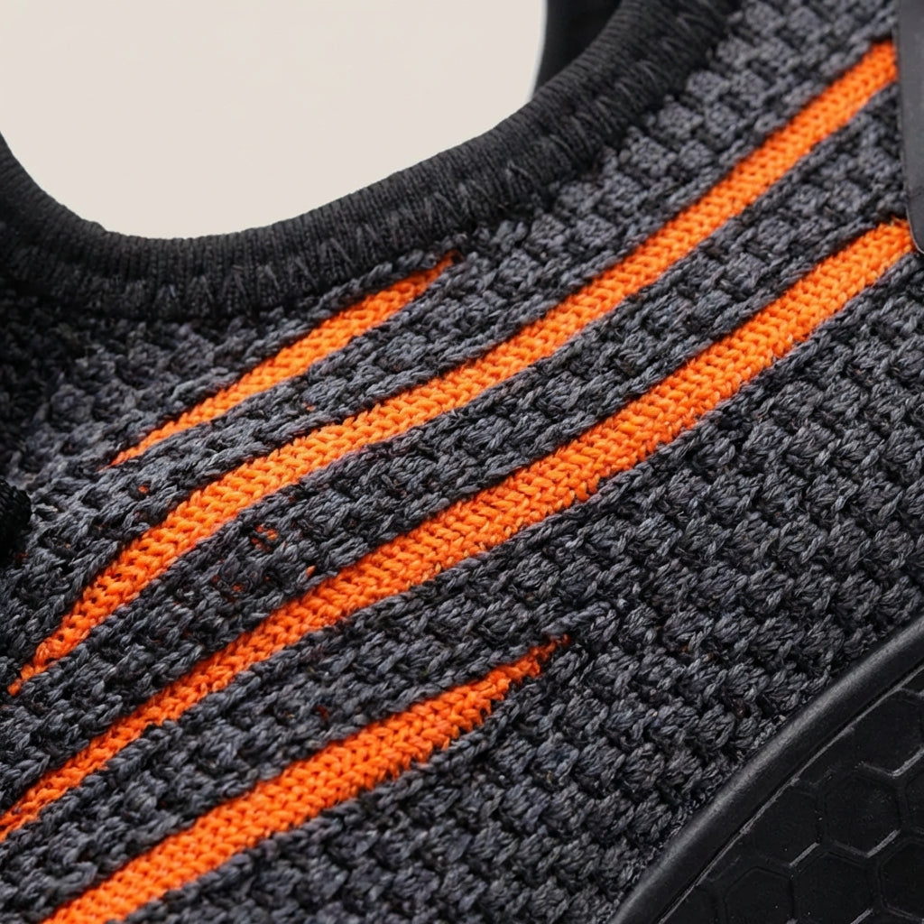 Low profile safety sneakers with reinforced toe protection and breathable upper
