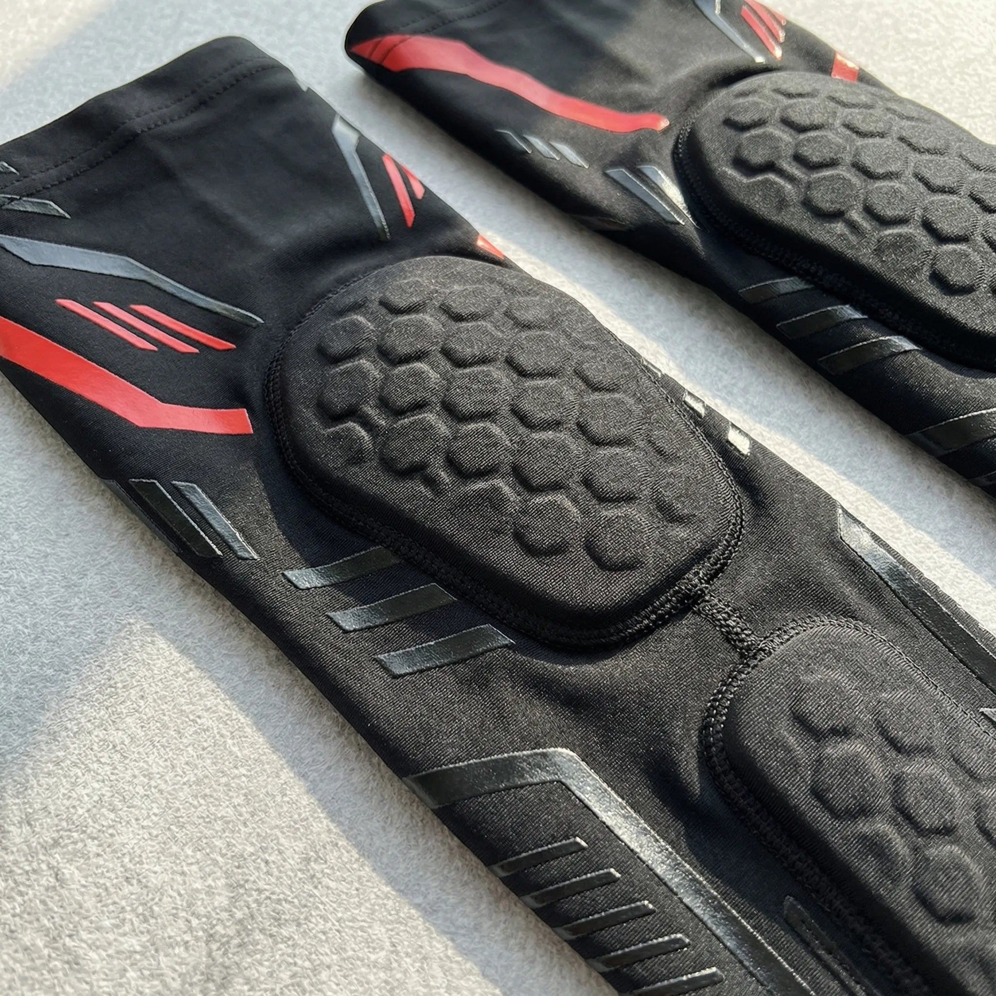 Padded compression arm sleeve with honeycomb elbow protection