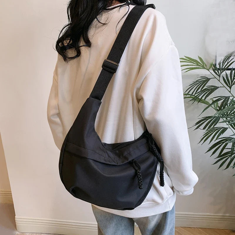 Compact crossbody sling bag with adjustable strap and organized pockets
