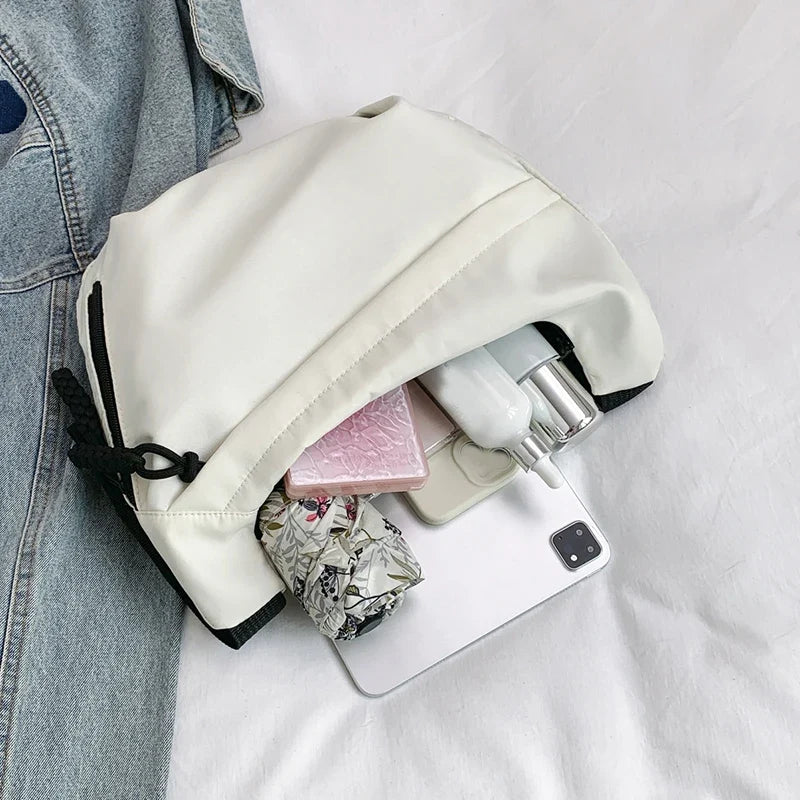 Compact crossbody sling bag with adjustable strap and organized pockets