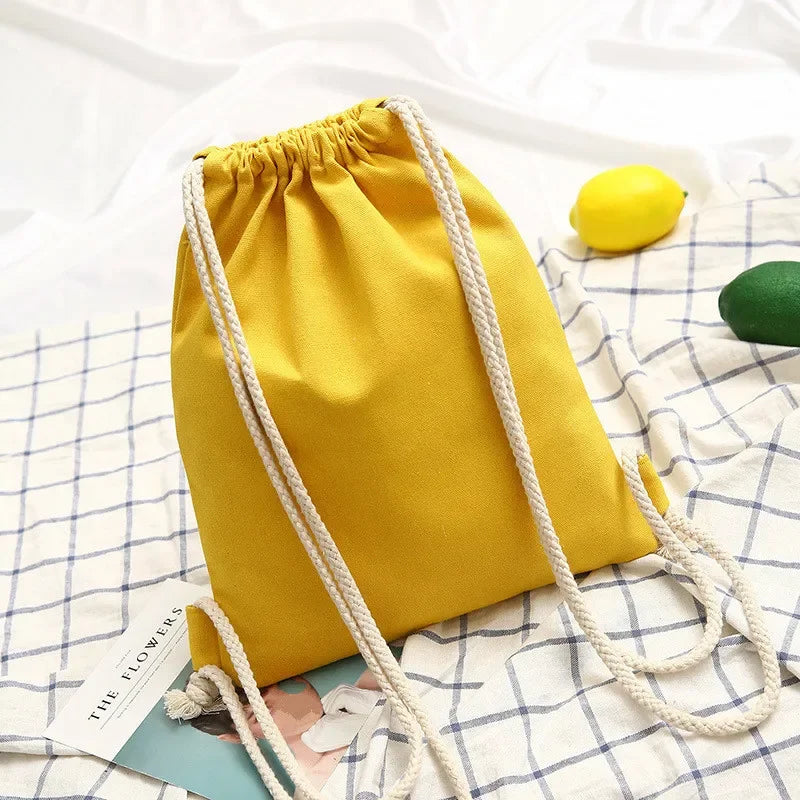 Lightweight drawstring backpack with soft canvas exterior and rope shoulder straps