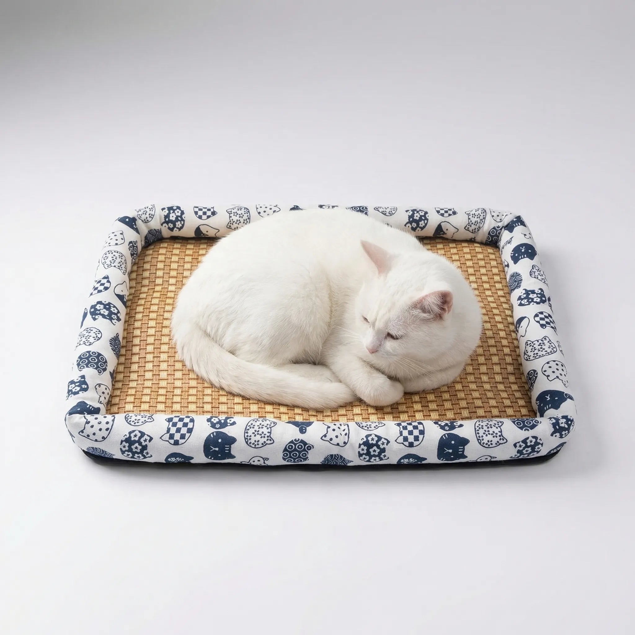 Woven rattan pet cooling mat with raised padded border
