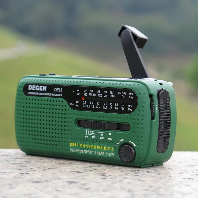 Hand crank emergency radio with built-in flashlight and USB charger