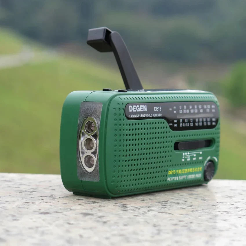 Hand crank emergency radio with built-in flashlight and USB charger
