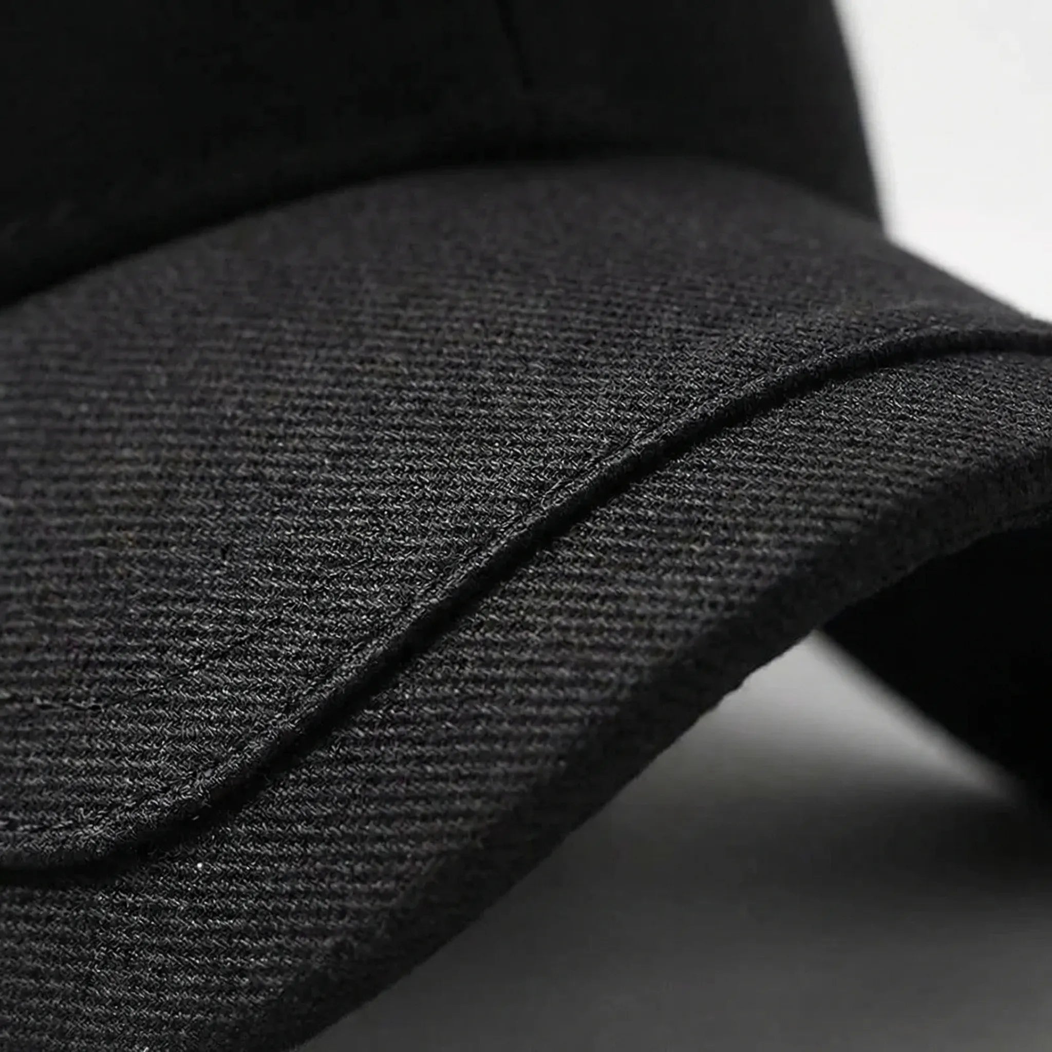 Minimalist baseball cap with curved peak and adjustable back strap