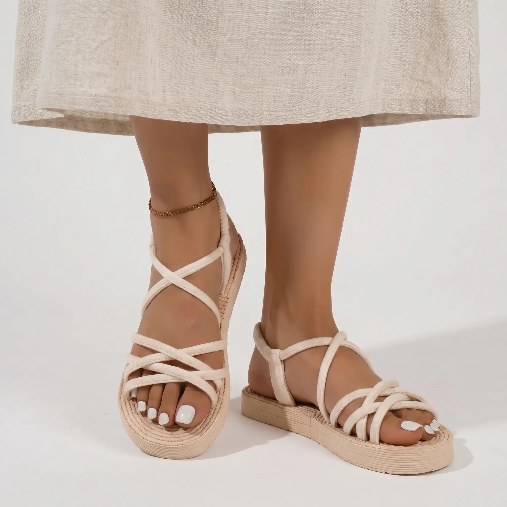 Flat strappy sandals with lightweight sole and cross-over strap pattern