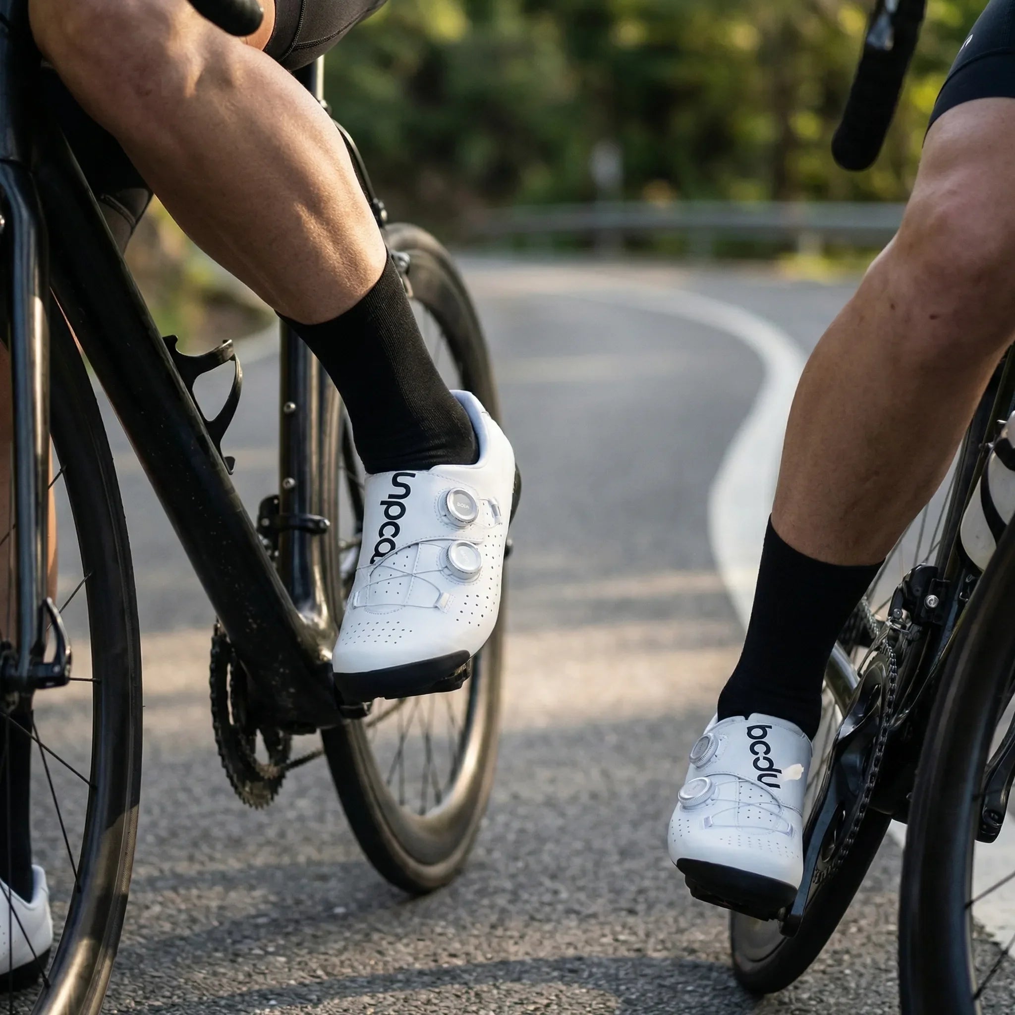 Lightweight road cycling shoes with rigid sole and perforated upper
