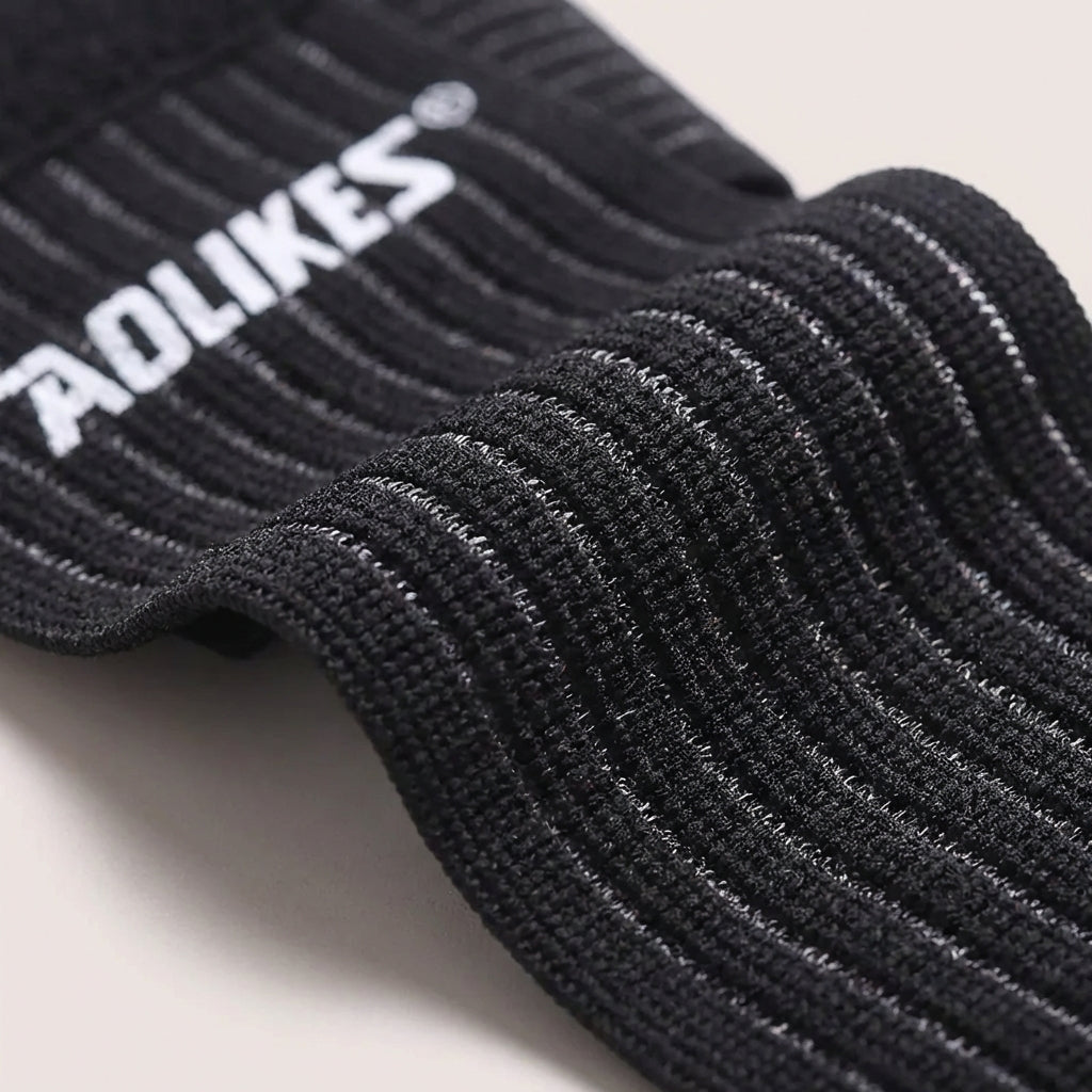 Adjustable ankle support wrap with targeted compression and breathable construction