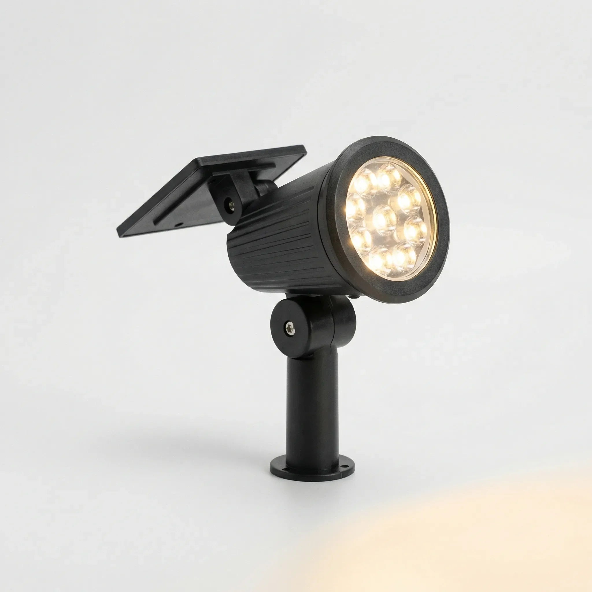 Solar-powered garden spotlight with adjustable LED beam and ground spike