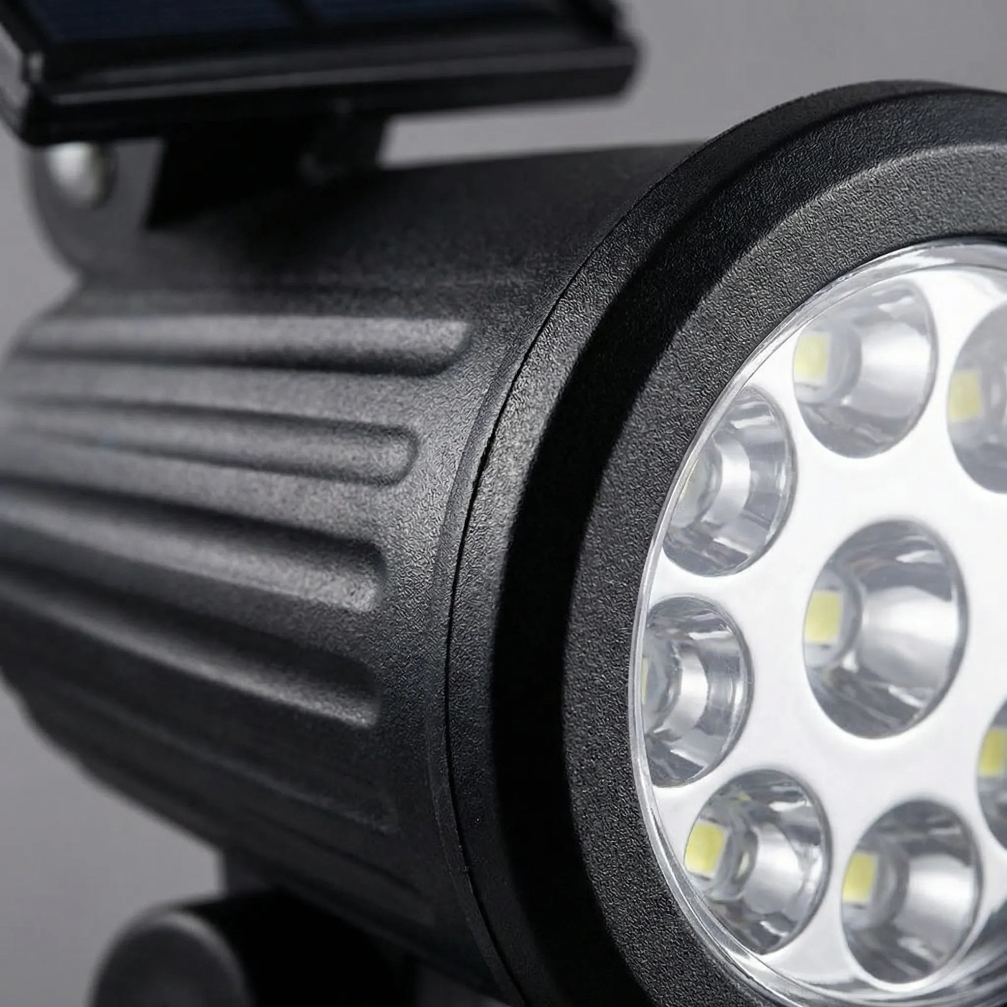 Solar-powered garden spotlight with adjustable LED beam and ground spike