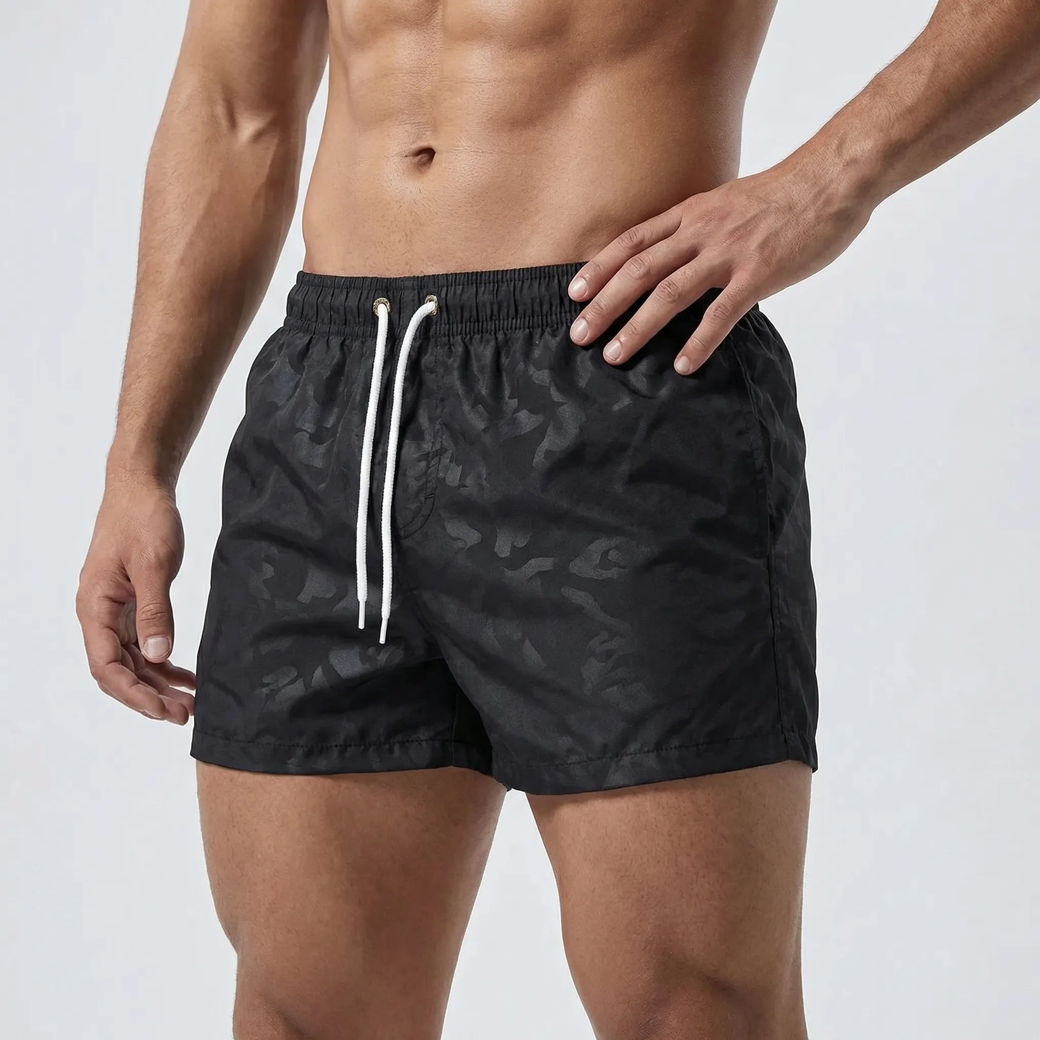 Men's low waist swim shorts with adjustable draw cord and curved hem