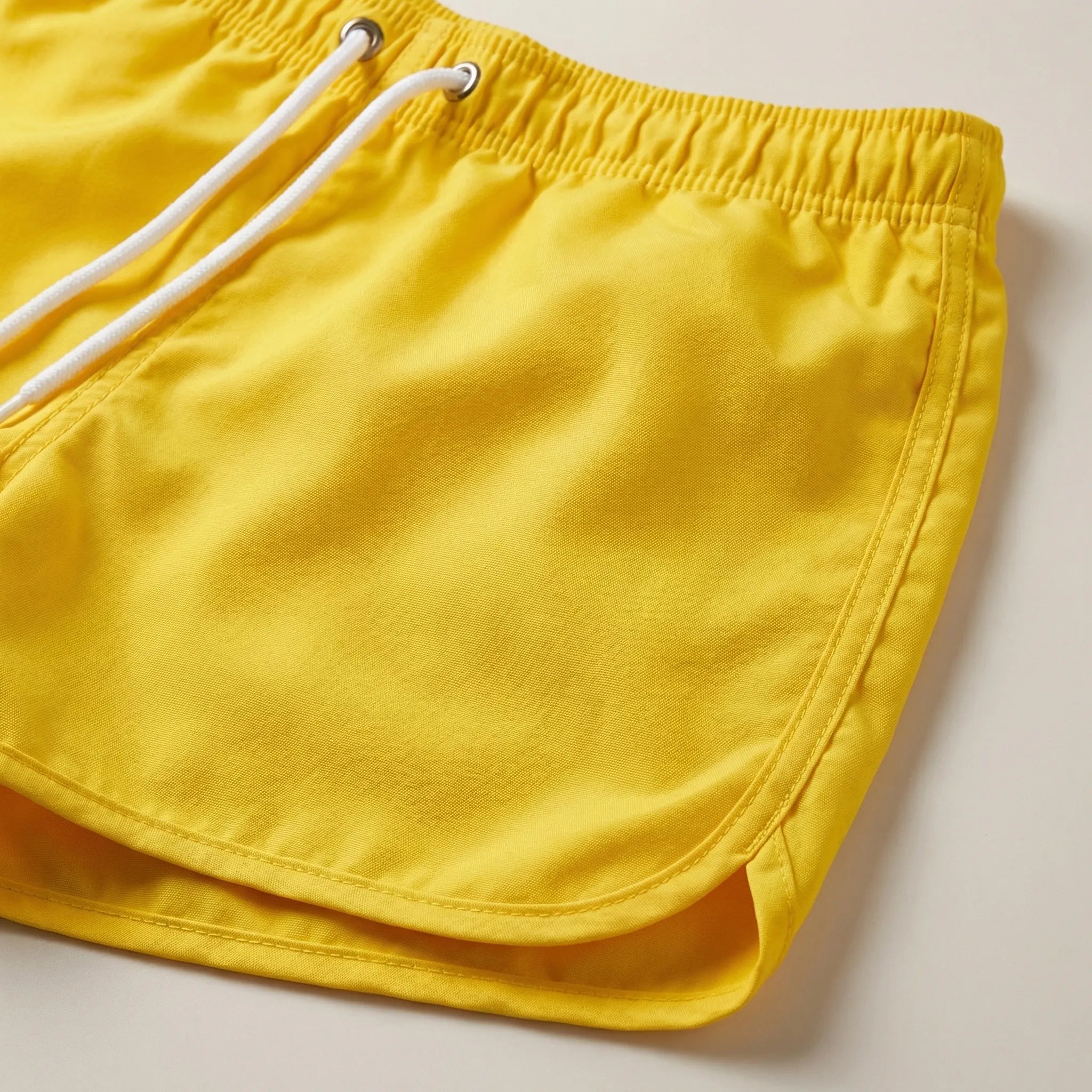 Men's low waist swim shorts with adjustable draw cord and curved hem