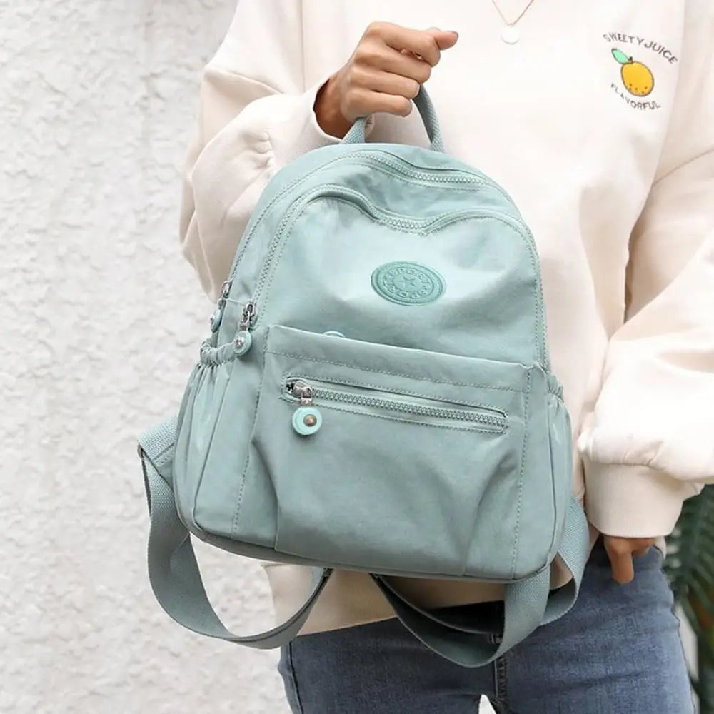 Compact mini backpack with anti-theft design and water-resistant fabric