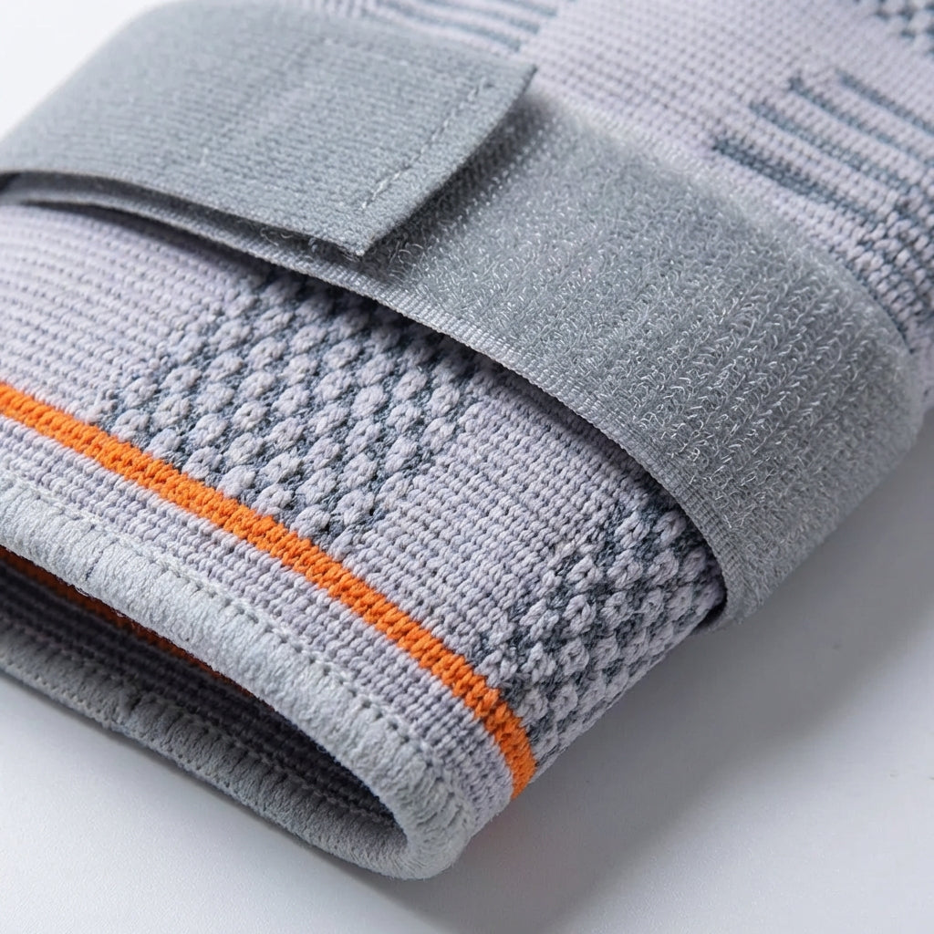 Adjustable compression elbow brace with padded support and breathable knit