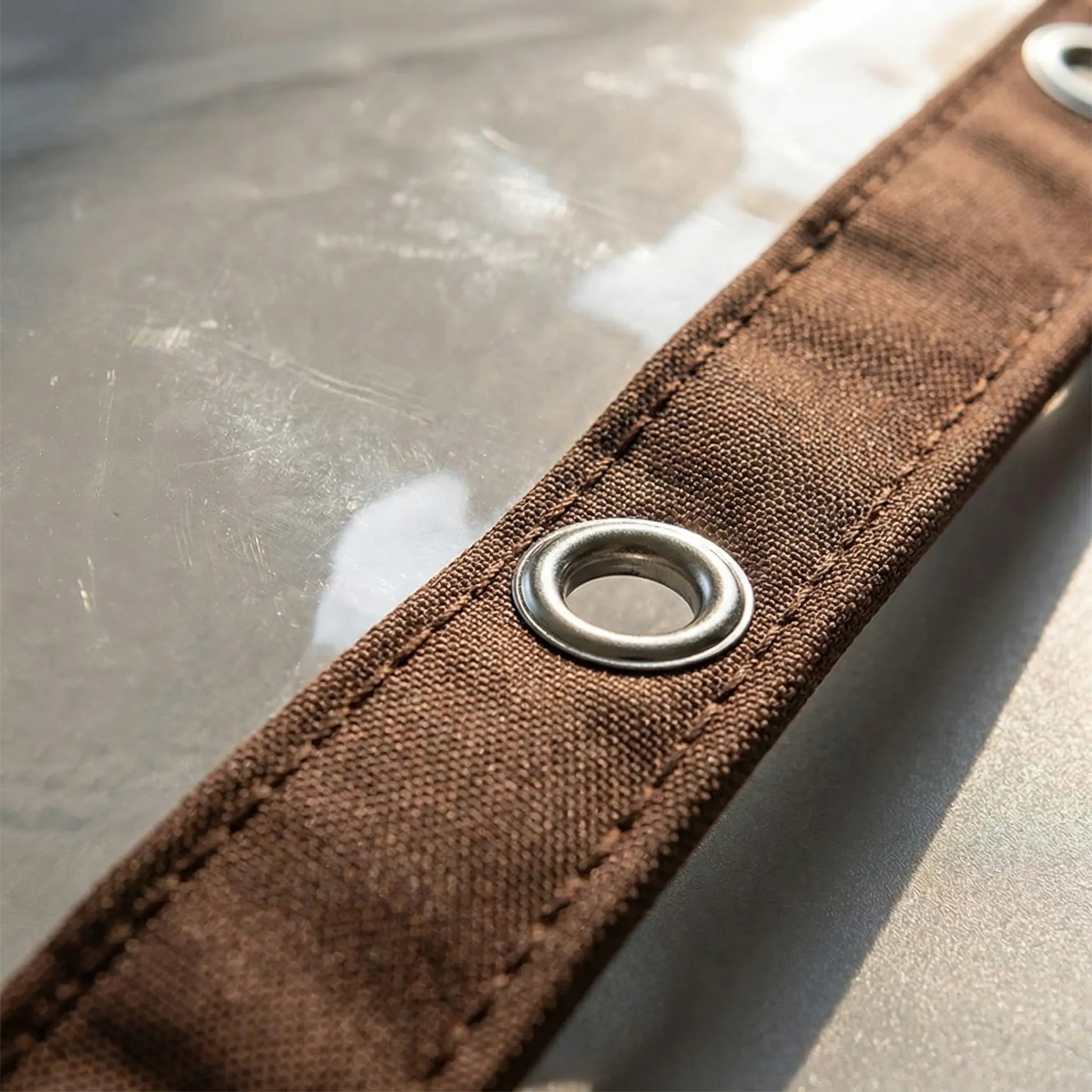 Transparent weather shield with clear light transmission and reinforced eyelets