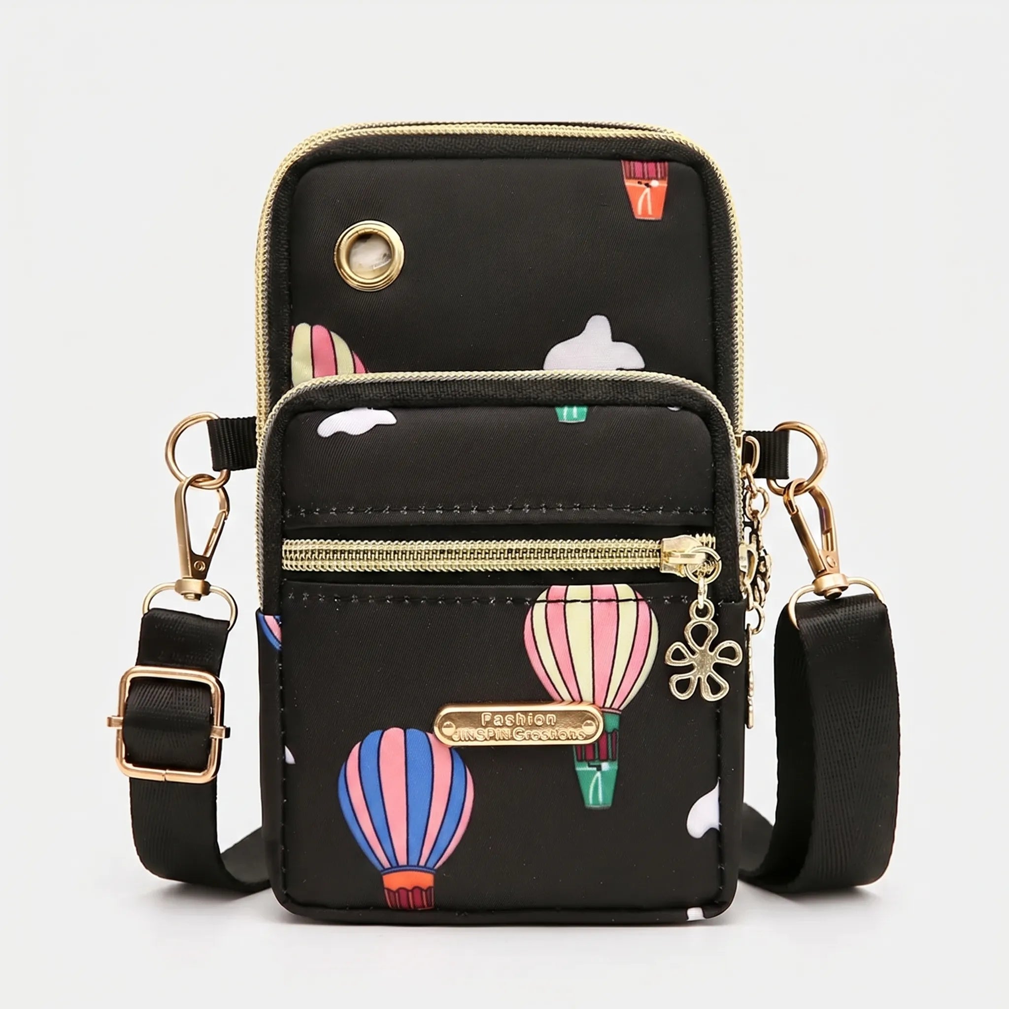 Compact crossbody bag with multiple zip pockets and adjustable strap