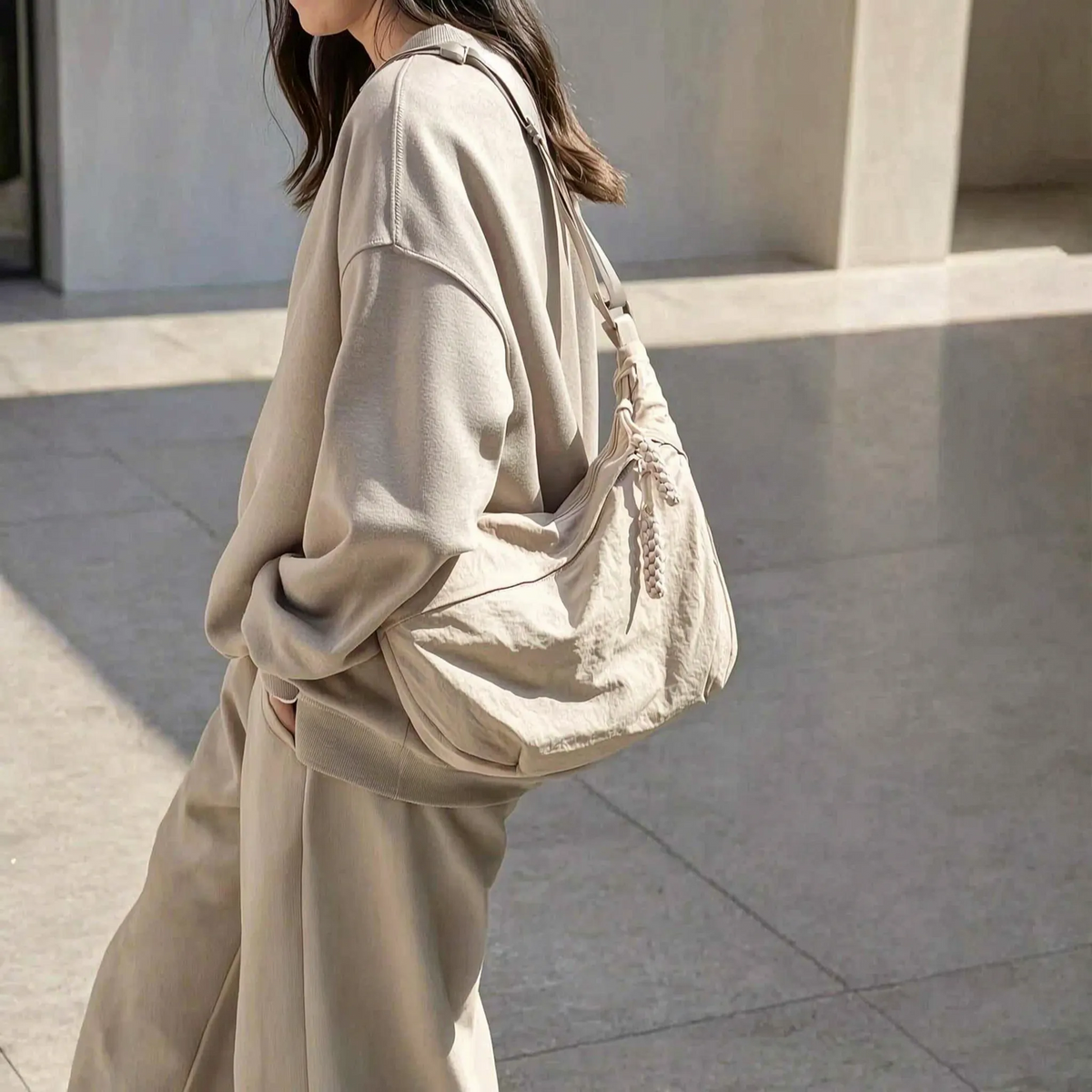 Large capacity shoulder bag with slouchy silhouette and front zip pocket