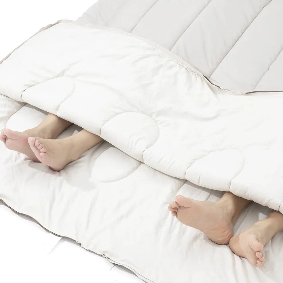 Convertible double sleeping bag with synthetic fiber insulation unzips into two single bags