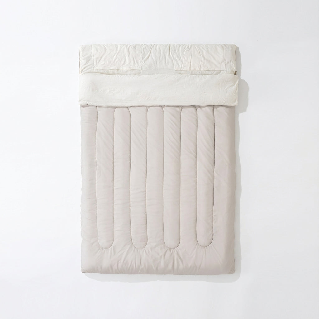 Convertible double sleeping bag with synthetic fiber insulation unzips into two single bags