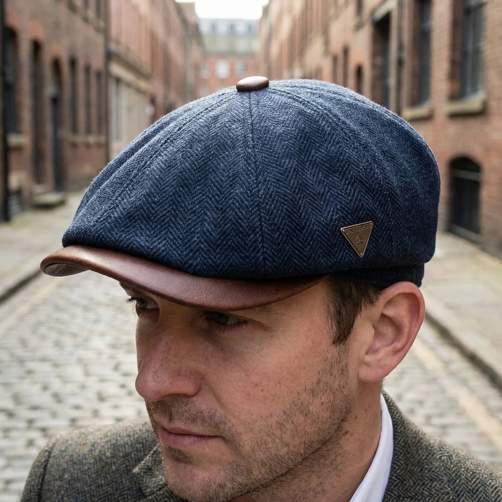 Men's classic flat cap with herringbone weave and metal badge detail