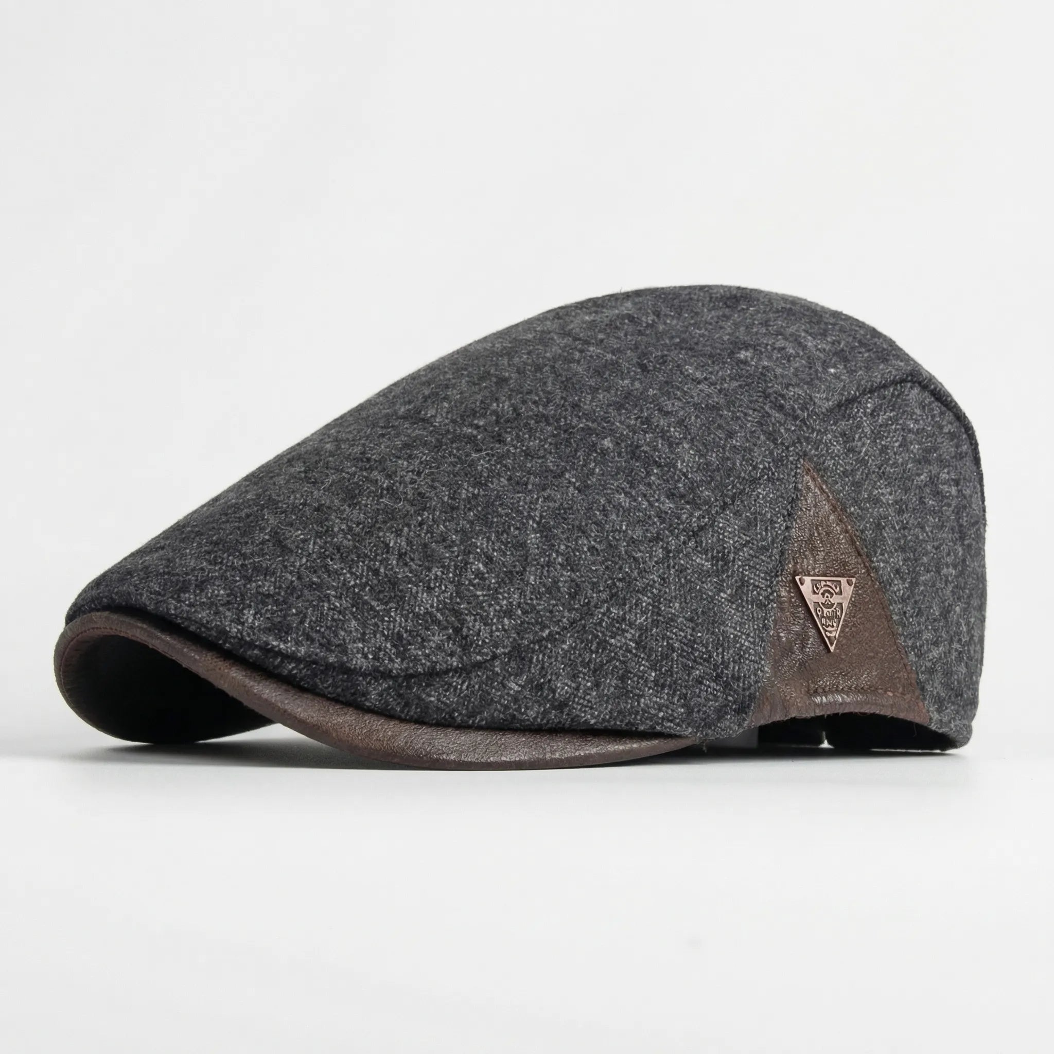 Men's herringbone flat cap with structured brim and triangular metal badge