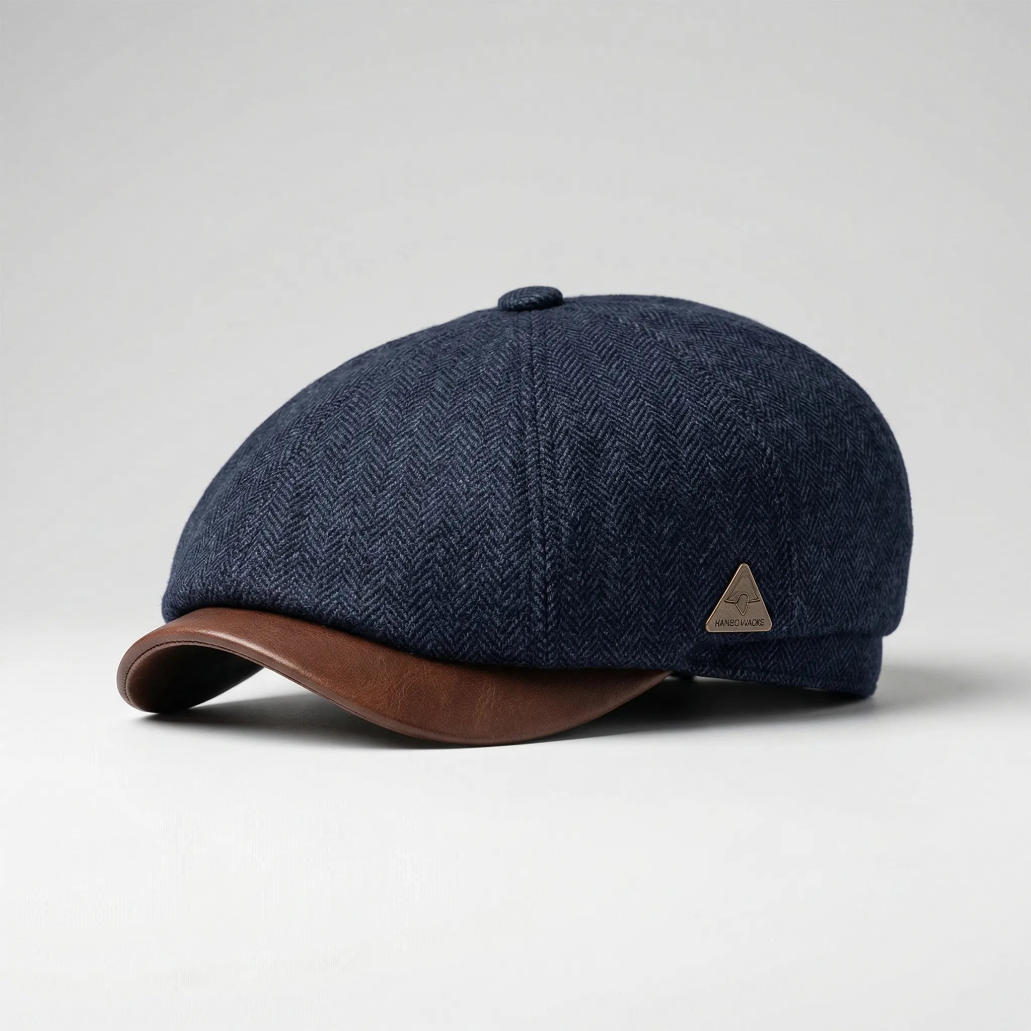 Men's classic flat cap with herringbone weave and metal badge detail