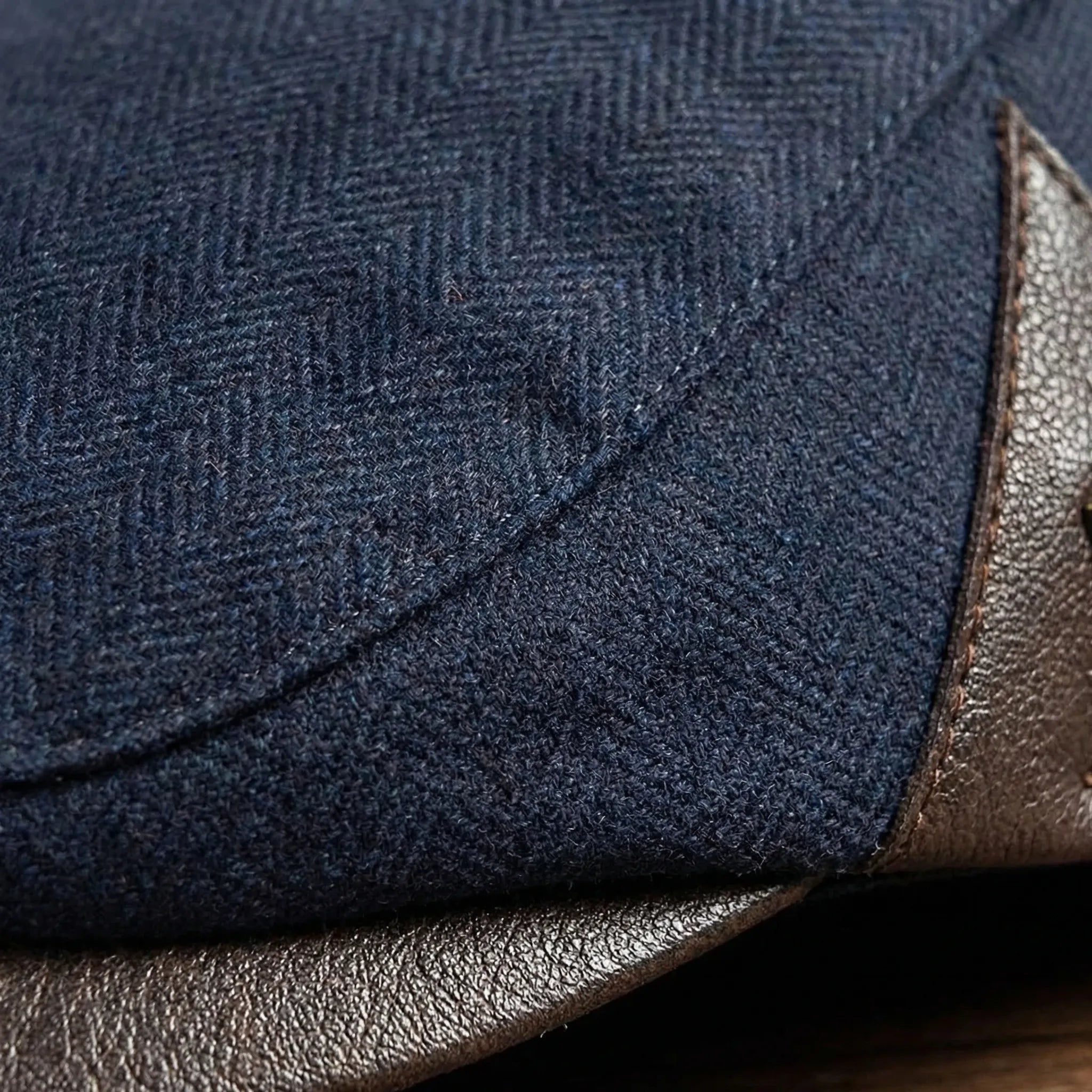 Men's classic flat cap with herringbone weave and metal badge detail