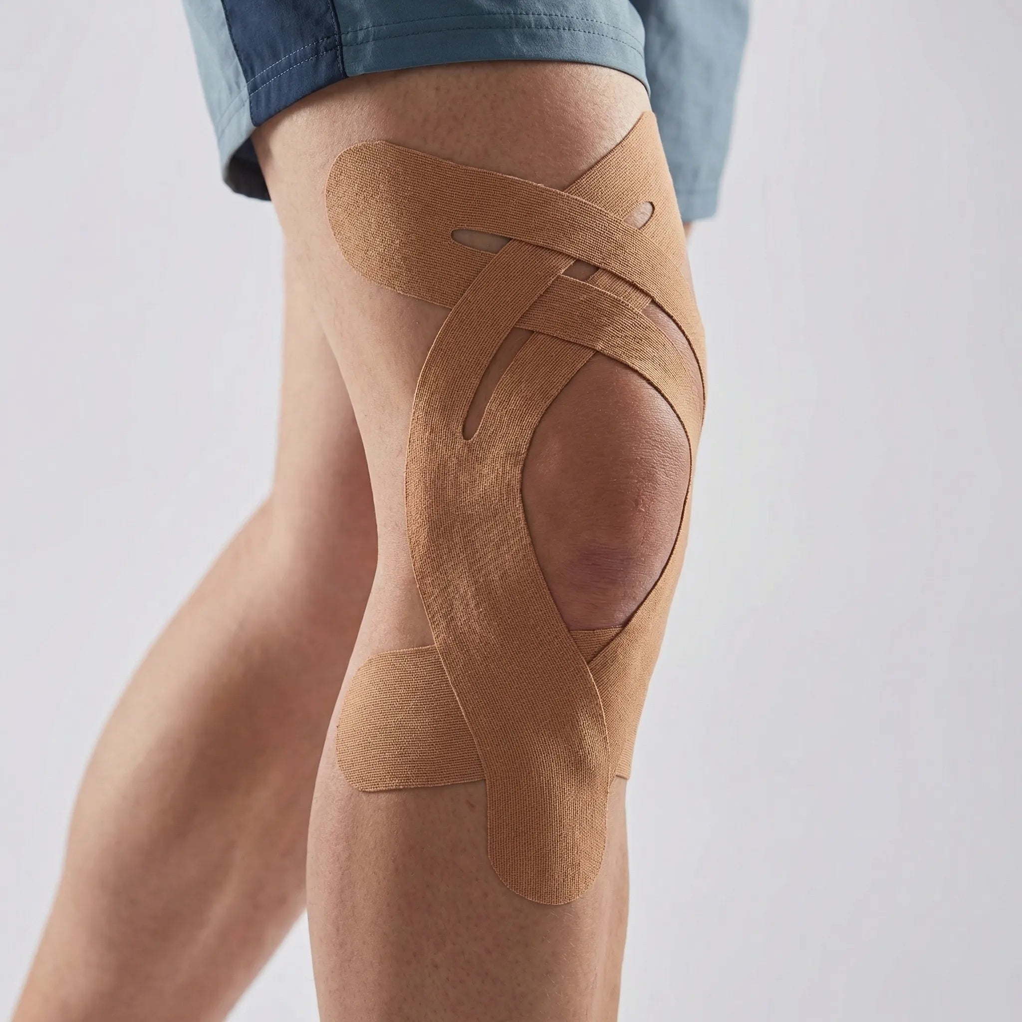 Elastic kinesiology knee tape with breathable fabric and water-resistant strips