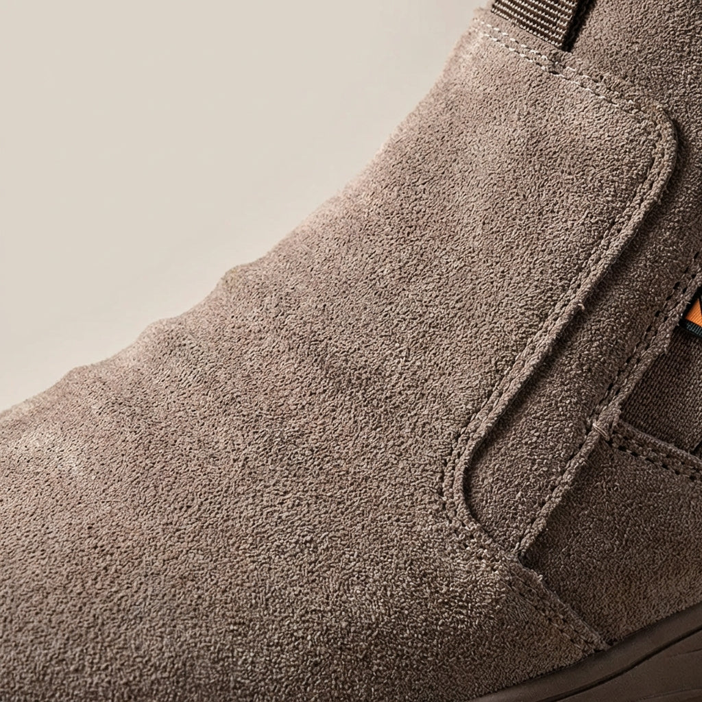 Slip-on safety boot with reinforced toe protection and puncture-resistant sole