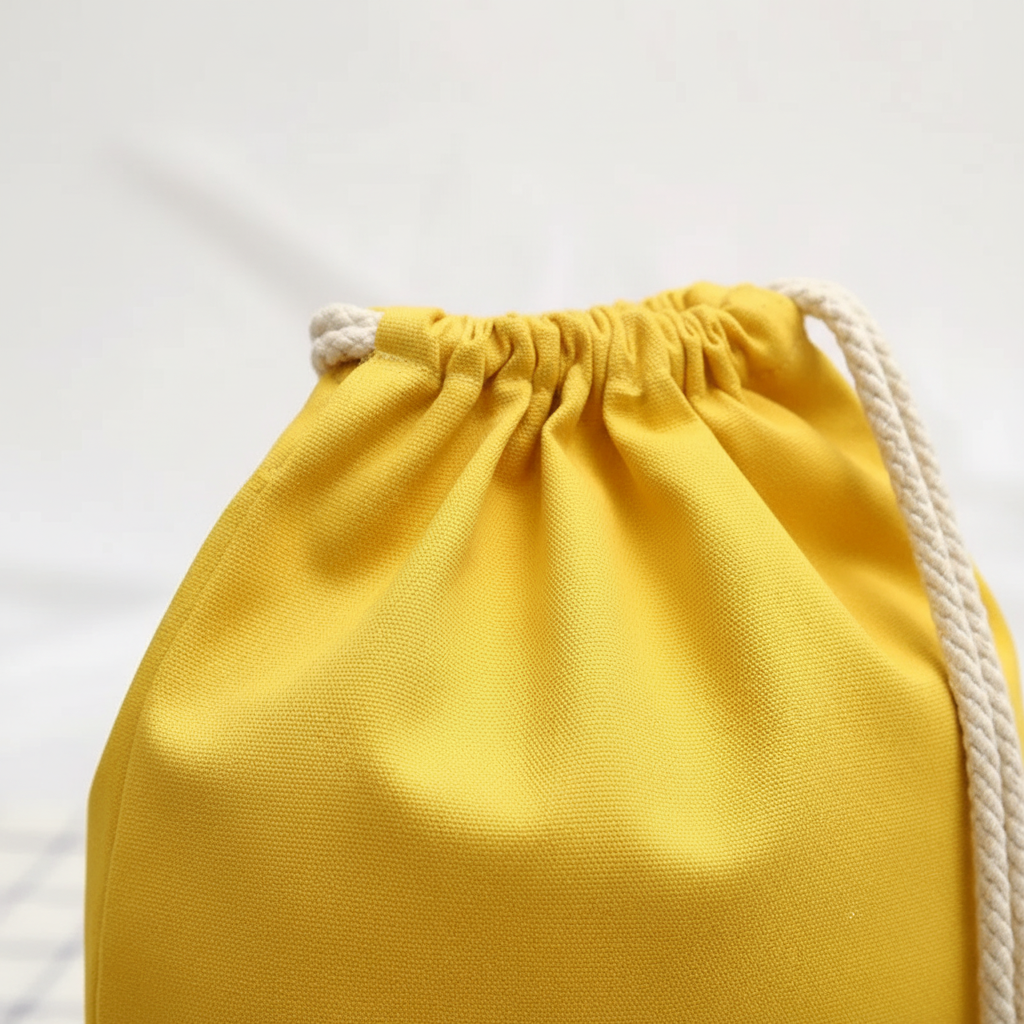 Lightweight drawstring backpack with soft canvas exterior and rope shoulder straps