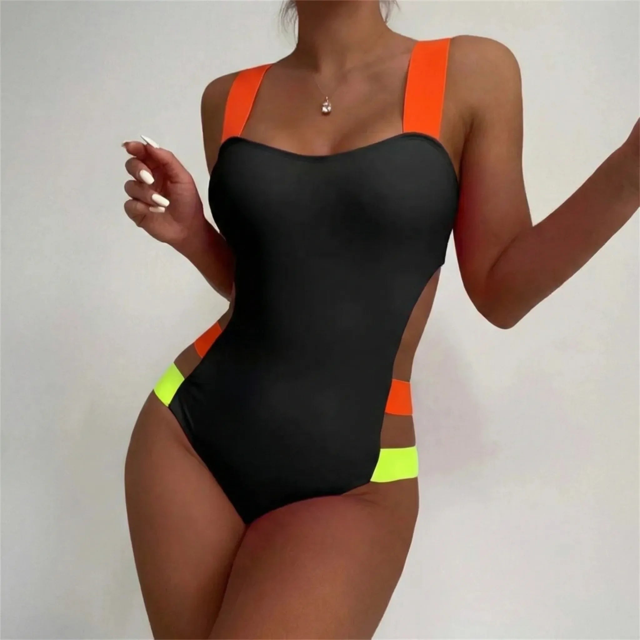 One-piece cutout swimsuit with neon contrast bands and open back