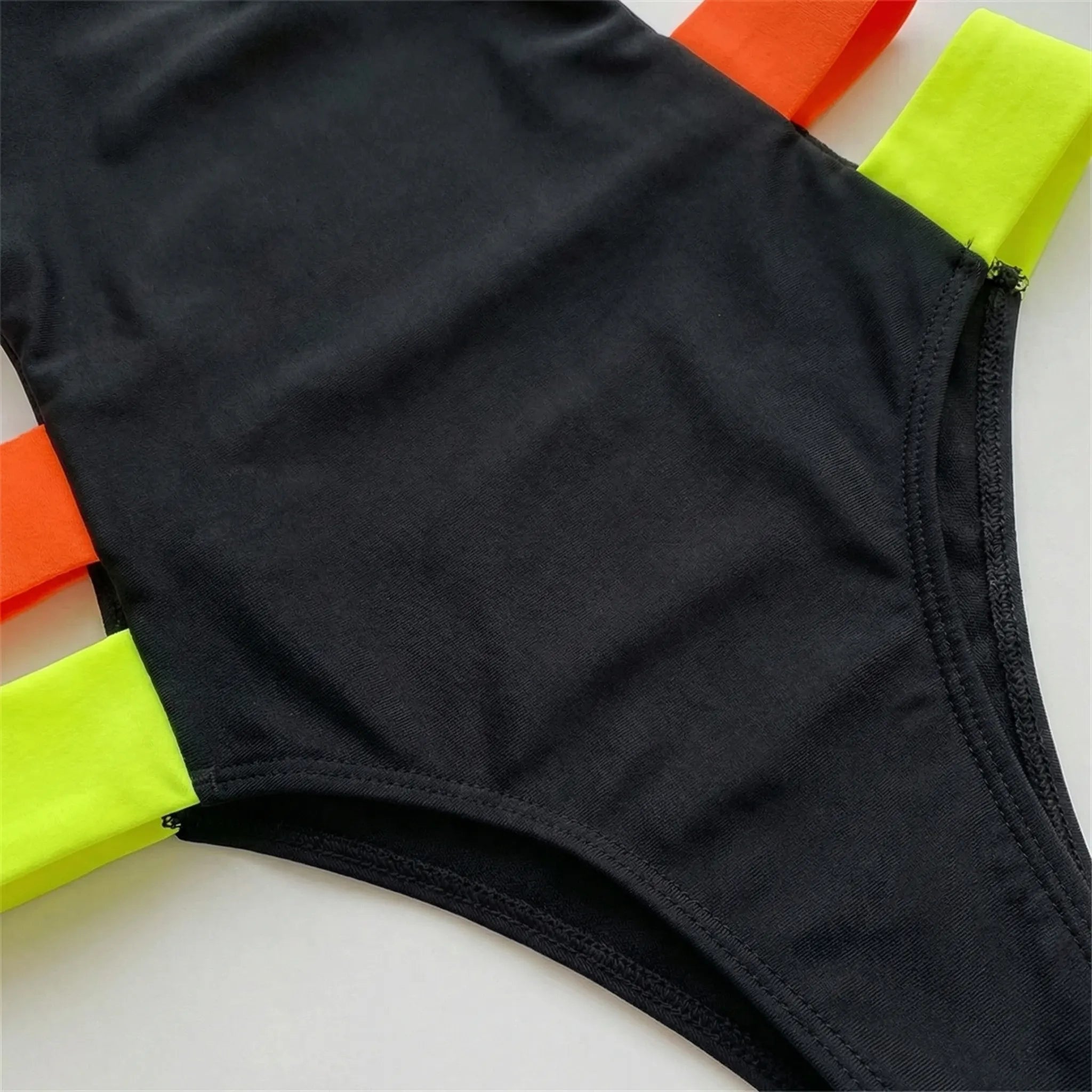 One-piece cutout swimsuit with neon contrast bands and open back