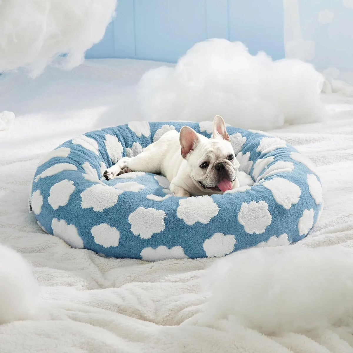 Round plush dog bed with raised bolstered rim, non-slip base, machine-washable