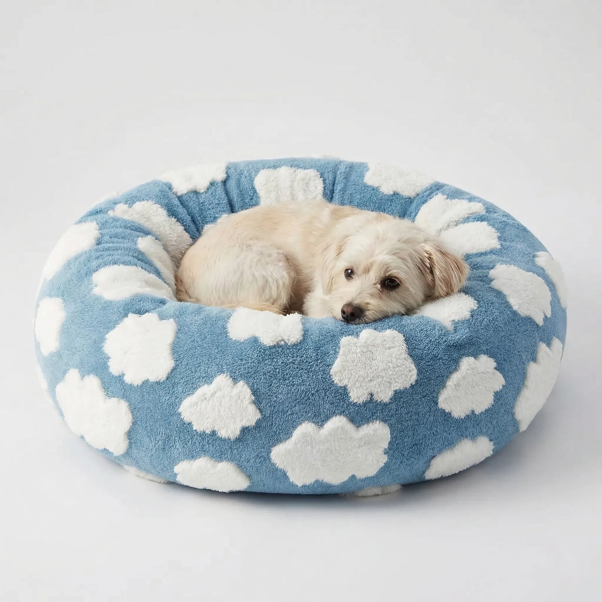 Round plush dog bed with raised bolstered rim, non-slip base, machine-washable