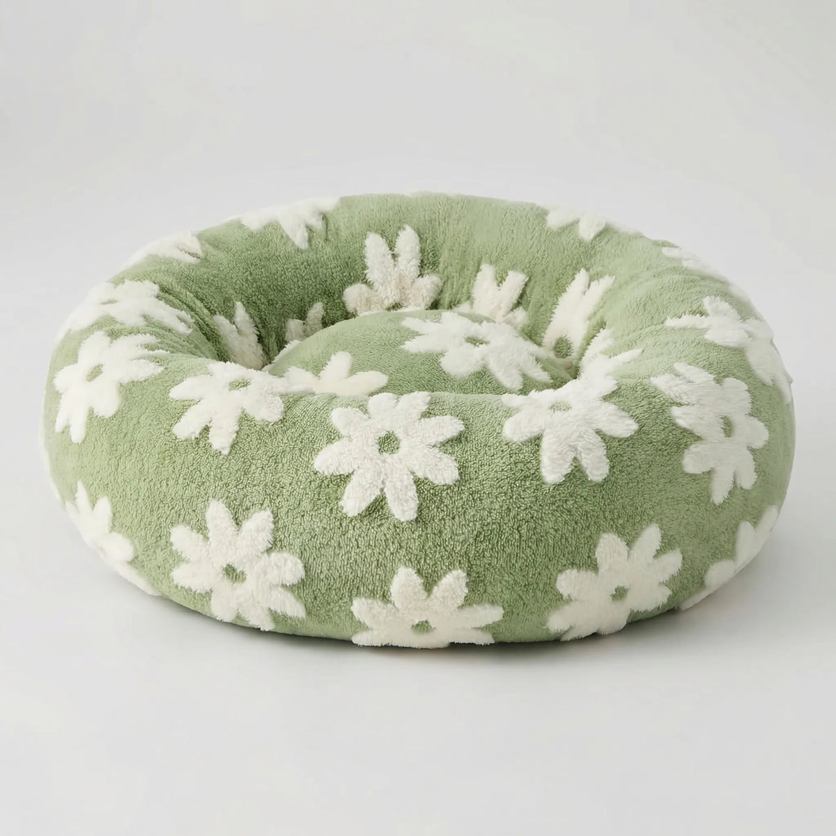 Round plush dog bed with raised bolstered rim, non-slip base, machine-washable