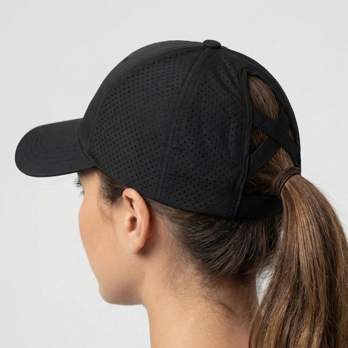 Women's sports cap with ponytail opening and structured peak