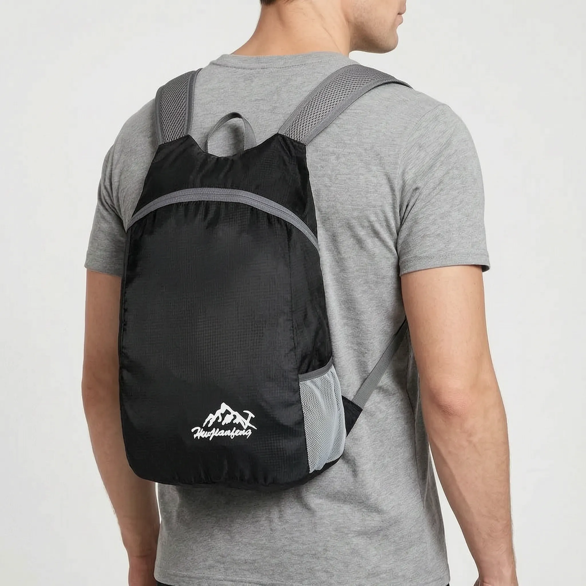 Foldable lightweight daypack with water-repellent outer shell and ventilated mesh straps