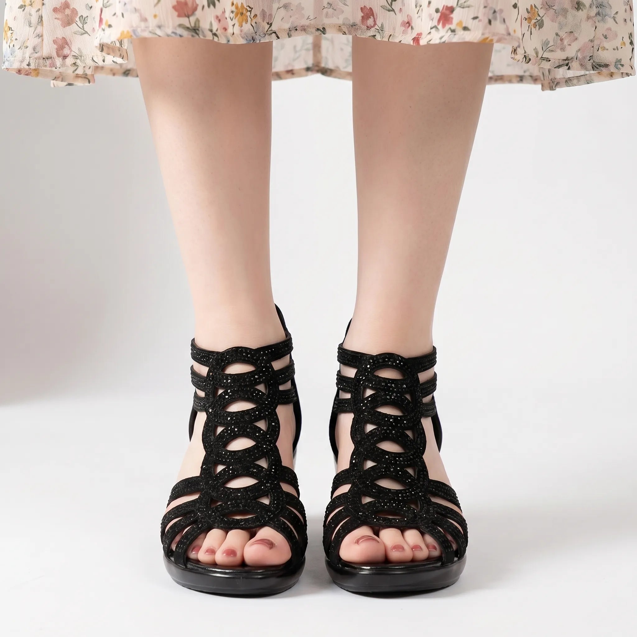 Black wedge sandal with cut-out straps and rhinestone embellishments