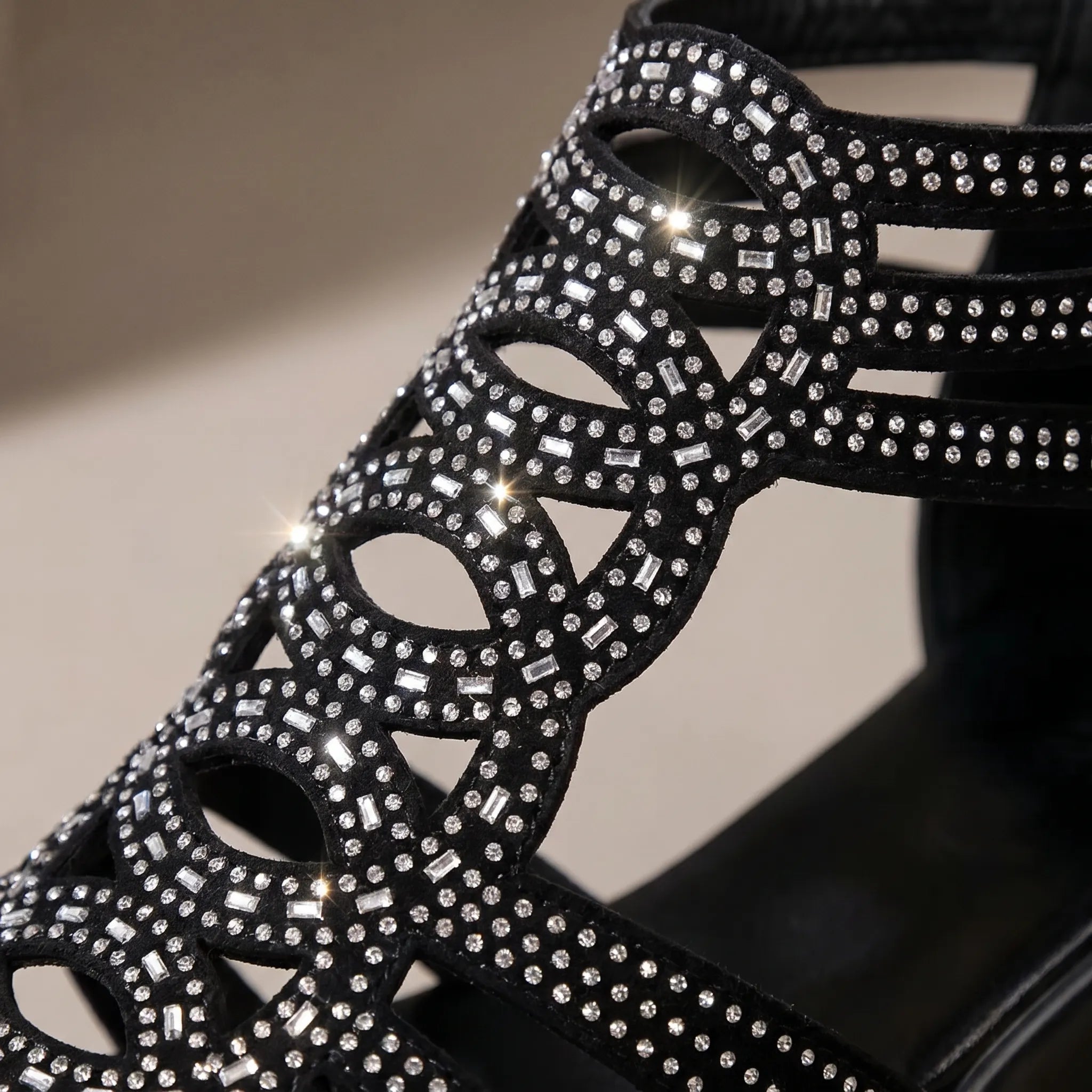 Black wedge sandal with cut-out straps and rhinestone embellishments