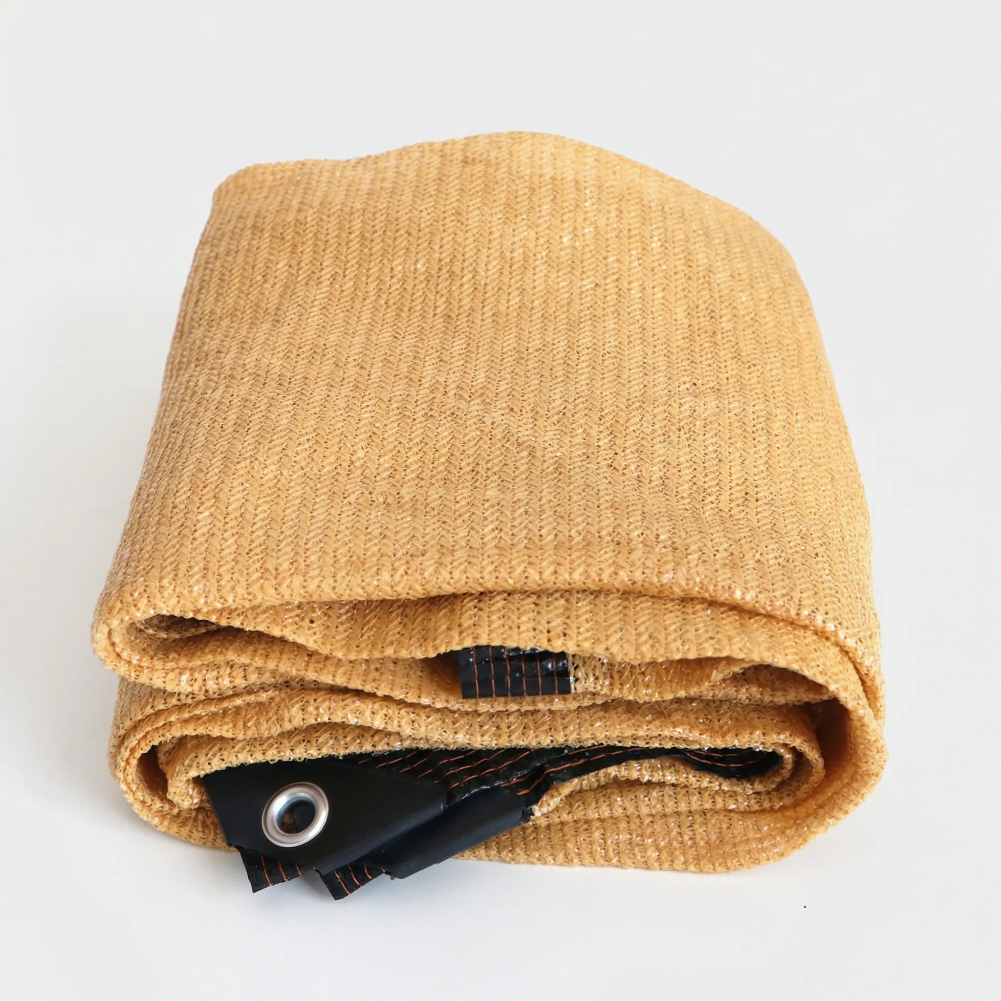 High coverage shade cloth with reinforced edges and metal eyelets for patio and garden use