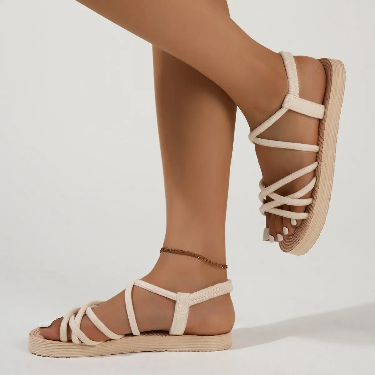 Flat strappy sandals with lightweight sole and cross-over strap pattern