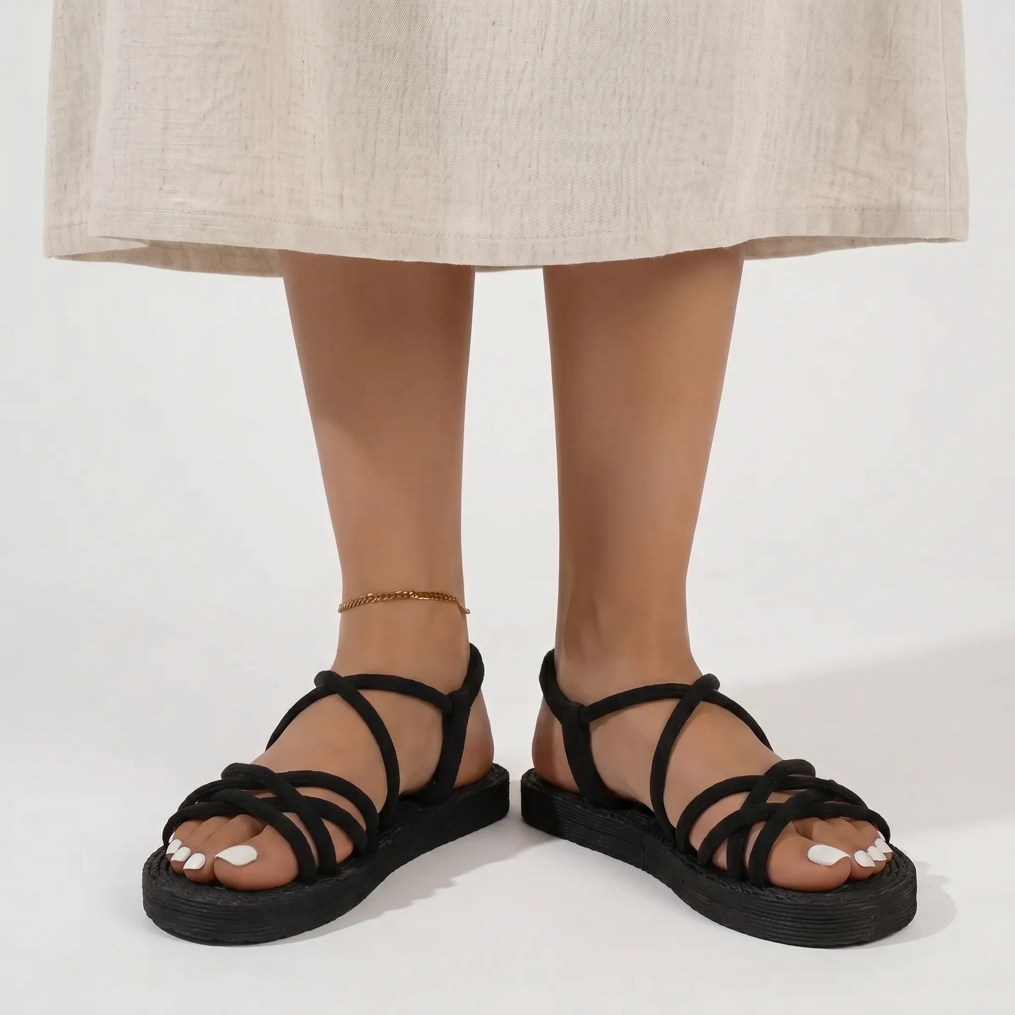 Flat strappy sandals with lightweight sole and cross-over strap pattern