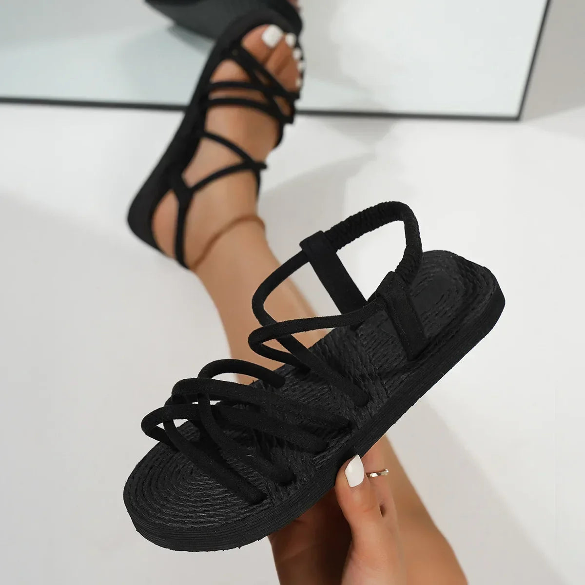 Flat strappy sandals with lightweight sole and cross-over strap pattern
