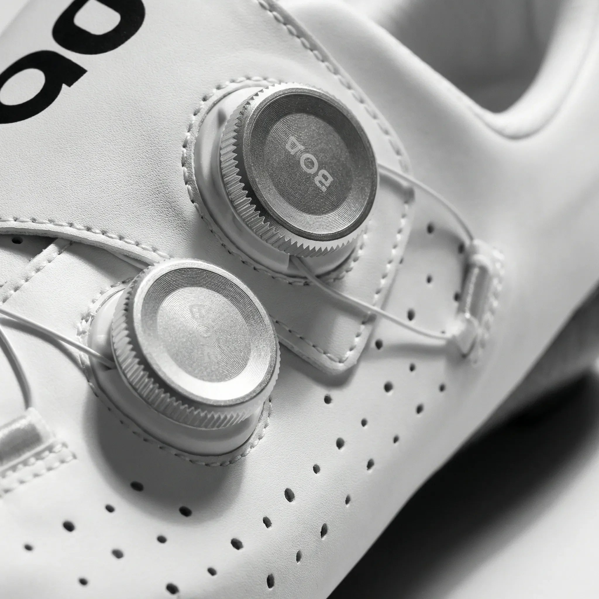 Lightweight road cycling shoes with rigid sole and perforated upper