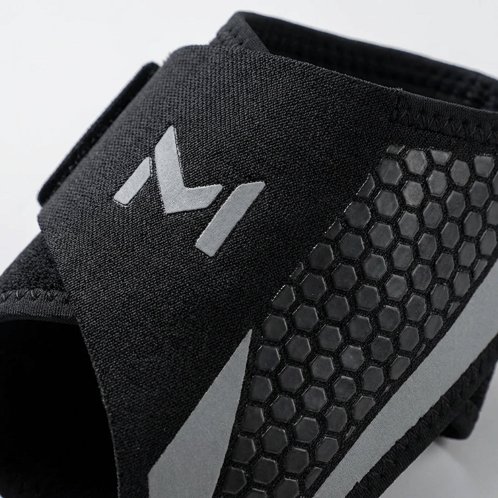 Adjustable ankle support with targeted compression and breathable construction