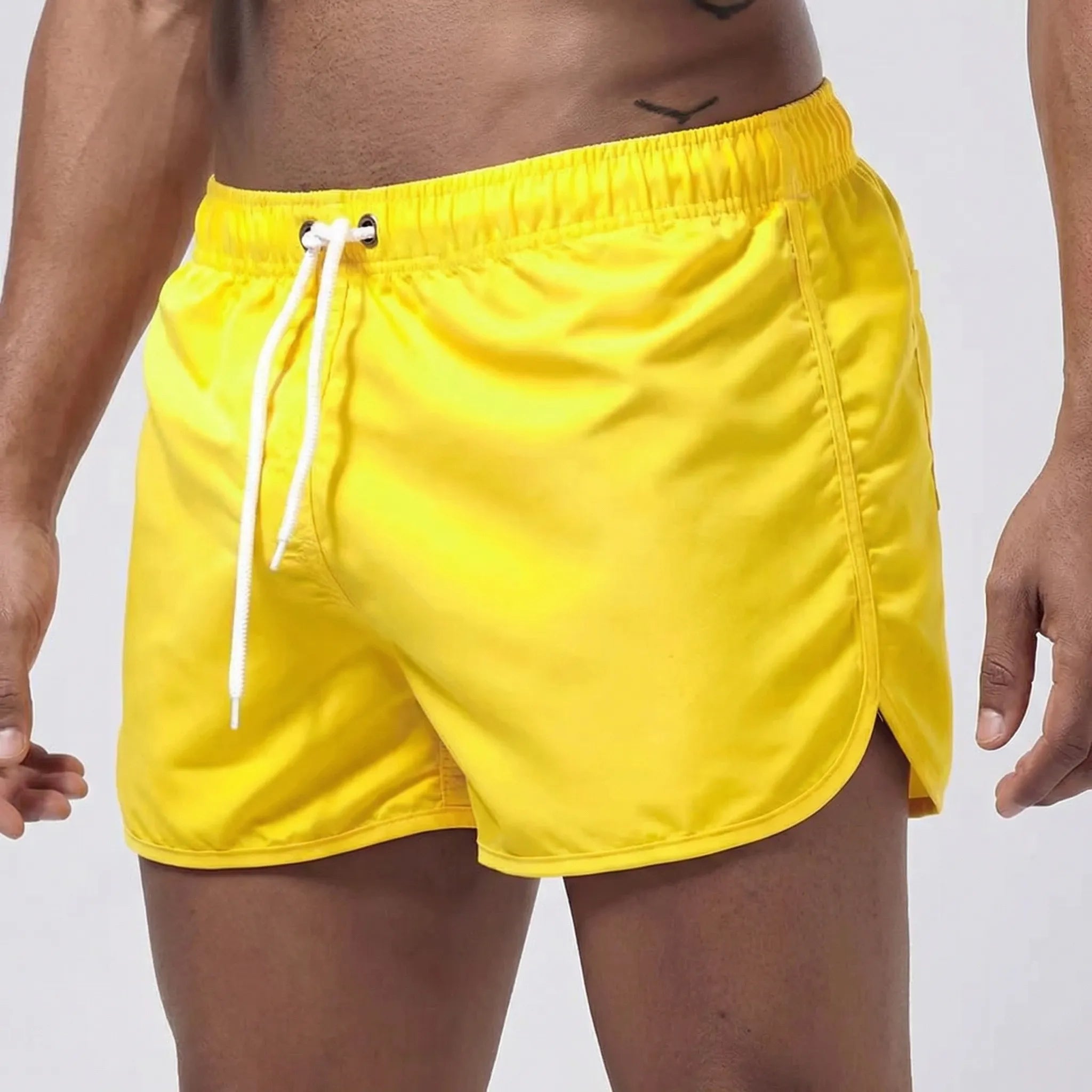 Men's low waist swim shorts with adjustable draw cord and curved hem