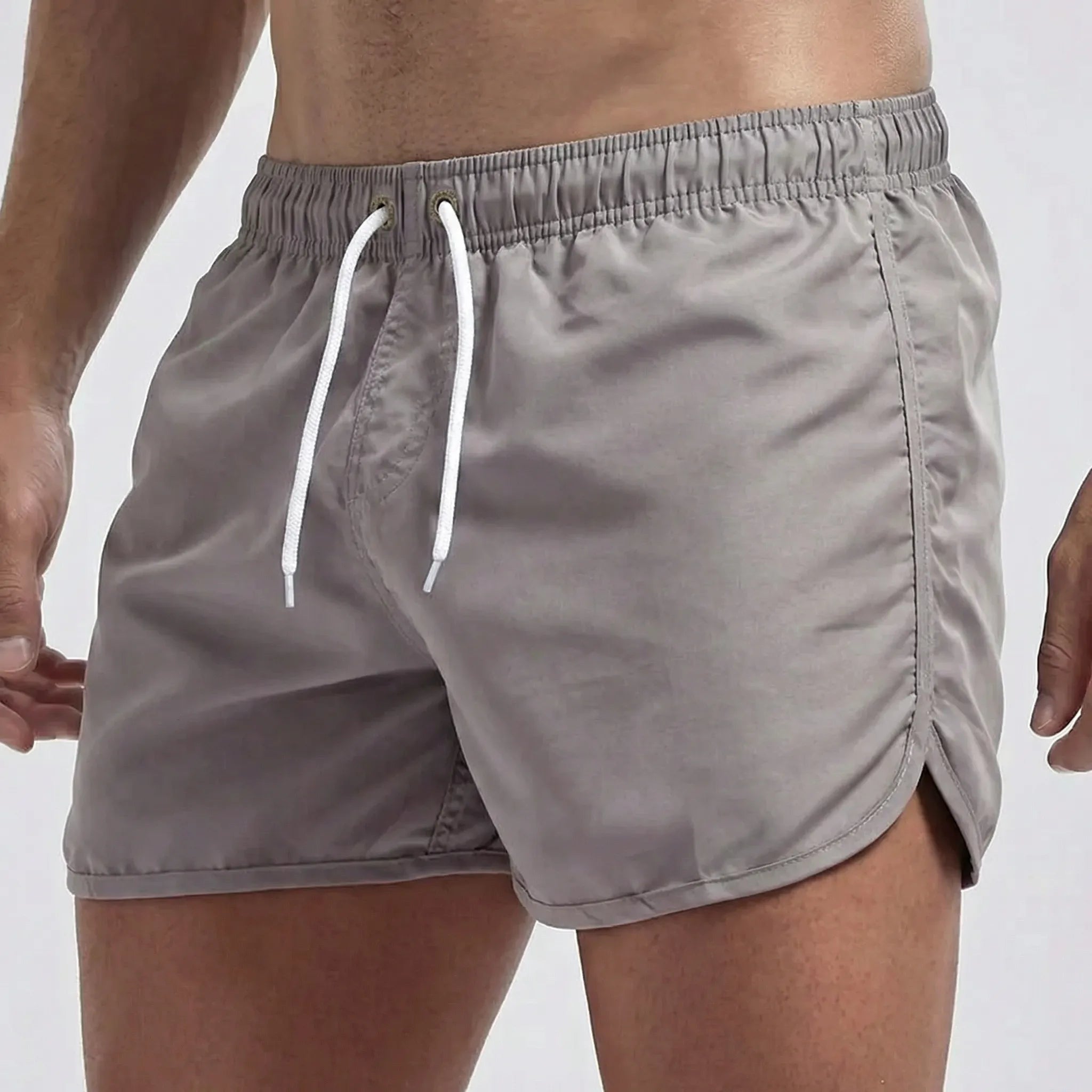 Men's low waist swim shorts with adjustable draw cord and curved hem