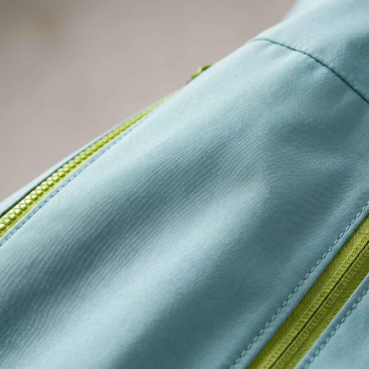 Women's waterproof hiking jacket with adjustable hood and zippered pockets